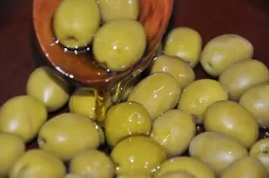 pooring oil on olives